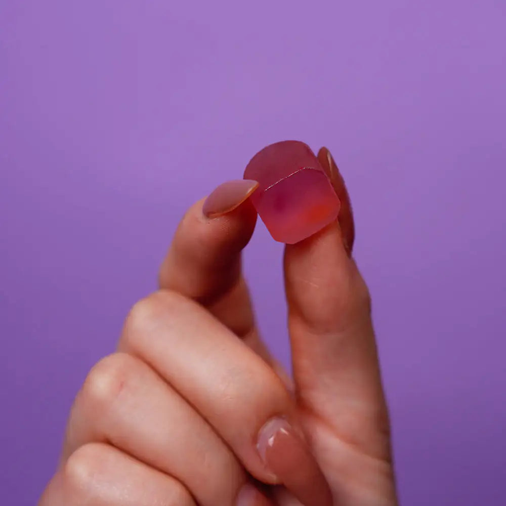 Nestrient GoSleep Melatonin-Free Sleep Gummies in acai berry flavor, featuring a close-up of the gummy supplement with berries.