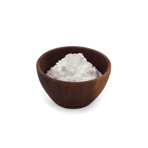 Brown bowl filled with white salt on a white background