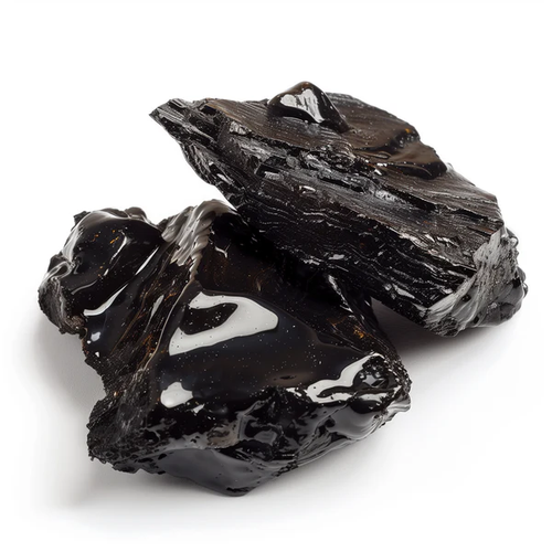 Two rough black obsidian rocks on a white background